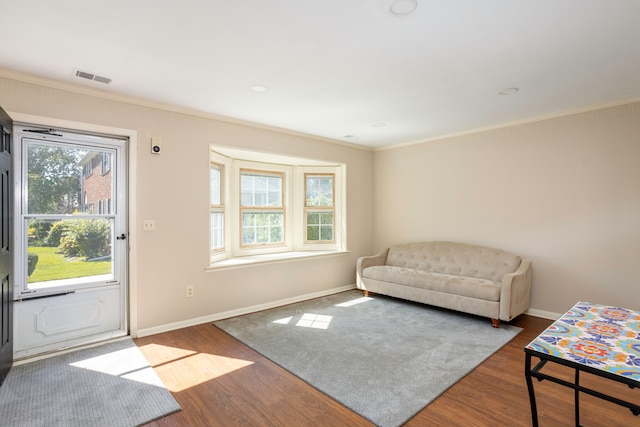 sitting room featuring hardwood / wood-style floors and crown molding