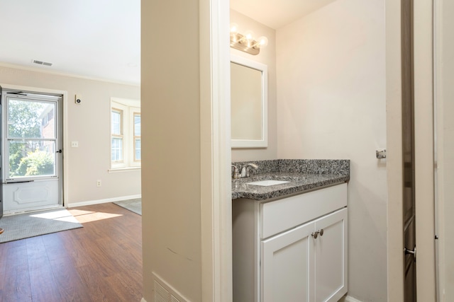 bathroom featuring hardwood / wood-style flooring, vanity, and an inviting chandelier