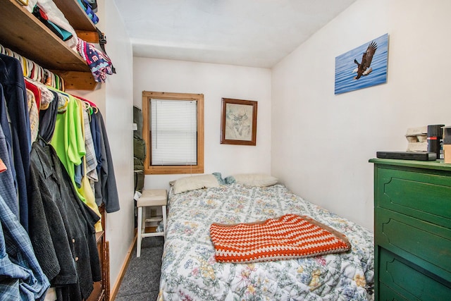 bedroom featuring dark colored carpet