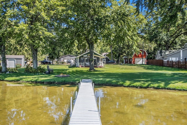 dock area featuring a lawn and a water view