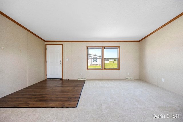 spare room with hardwood / wood-style floors and crown molding