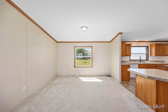 kitchen featuring light carpet, sink, ornamental molding, and dishwasher