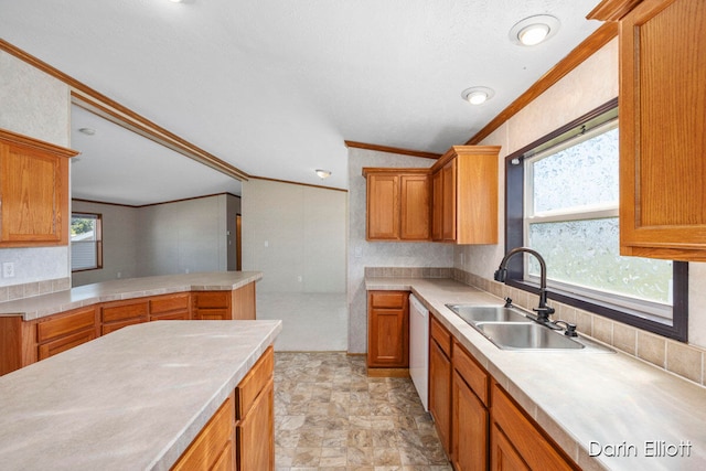 kitchen with sink, crown molding, vaulted ceiling, white dishwasher, and kitchen peninsula