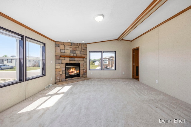 unfurnished living room featuring crown molding, a fireplace, light colored carpet, and vaulted ceiling