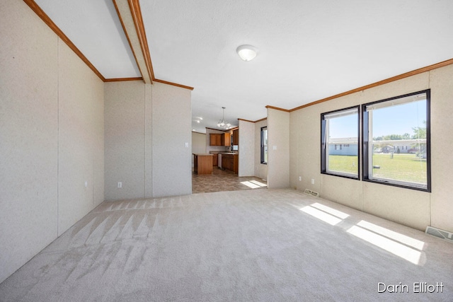 unfurnished living room featuring an inviting chandelier, ornamental molding, vaulted ceiling, and light carpet