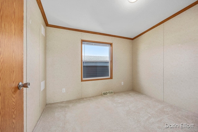 unfurnished room with crown molding and light carpet