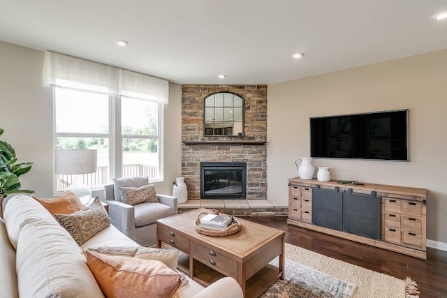 living room with dark wood-type flooring and a fireplace