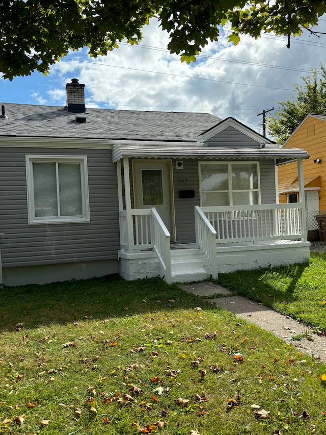 view of front of home featuring covered porch and a front lawn