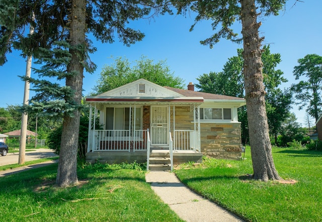 bungalow-style house featuring a porch and a front lawn