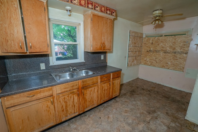 kitchen featuring tasteful backsplash, ceiling fan, and sink