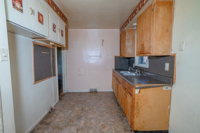 kitchen featuring decorative backsplash and sink