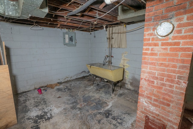 basement featuring electric panel and sink