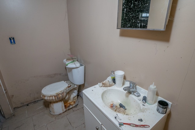 bathroom with tile patterned floors, vanity, and toilet