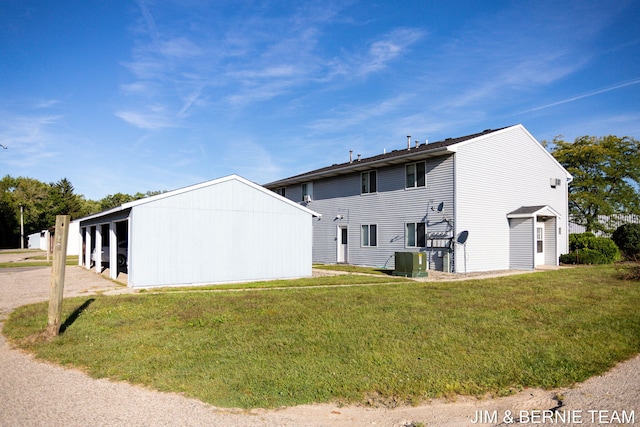 exterior space featuring a yard and central AC