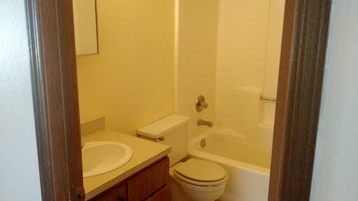 full bathroom with vanity, toilet, and tub / shower combination