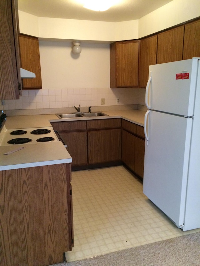 kitchen featuring white appliances, ventilation hood, tasteful backsplash, and sink