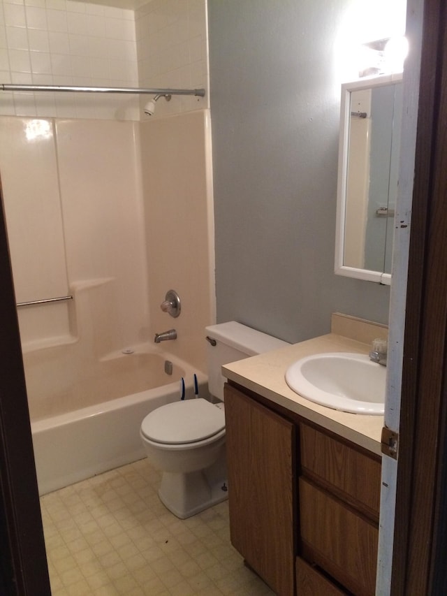 full bathroom featuring toilet, vanity, and tub / shower combination