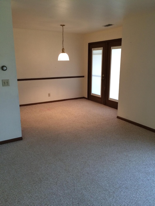 carpeted empty room with french doors