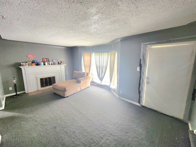 unfurnished living room with carpet flooring and a textured ceiling