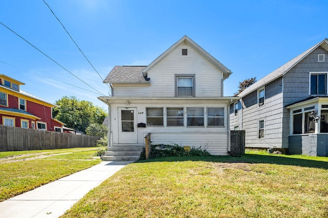 view of front of house featuring a front yard and a sunroom