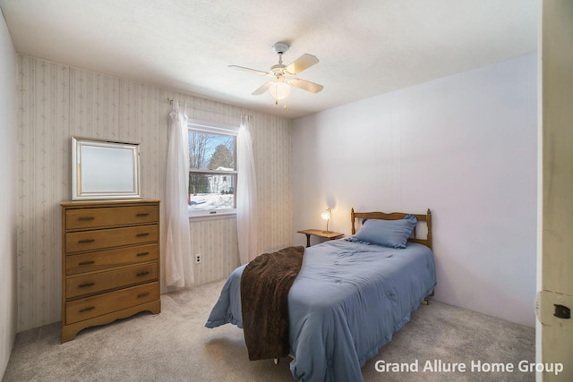 bedroom with ceiling fan and light carpet