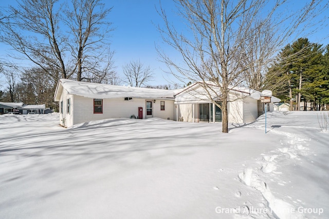 view of snow covered rear of property