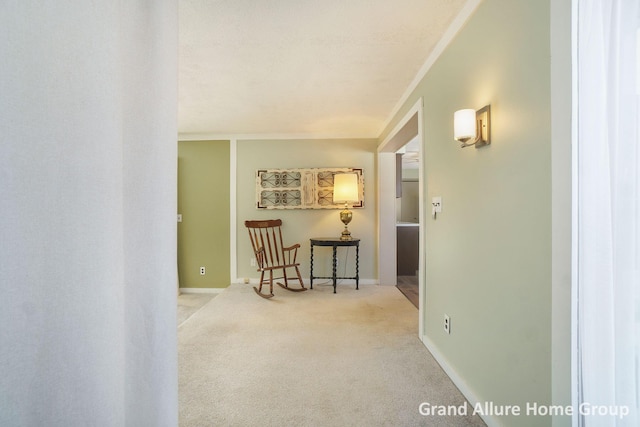 corridor featuring ornamental molding and light carpet