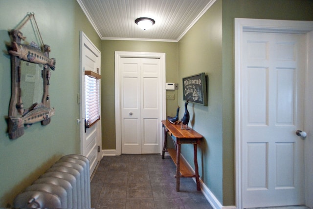 foyer entrance featuring radiator heating unit and ornamental molding