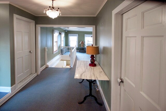 260 Oak Island Dr, Wolverine Lake, MI 48390 - corridor featuring carpet, baseboards, ornamental molding, and a chandelier