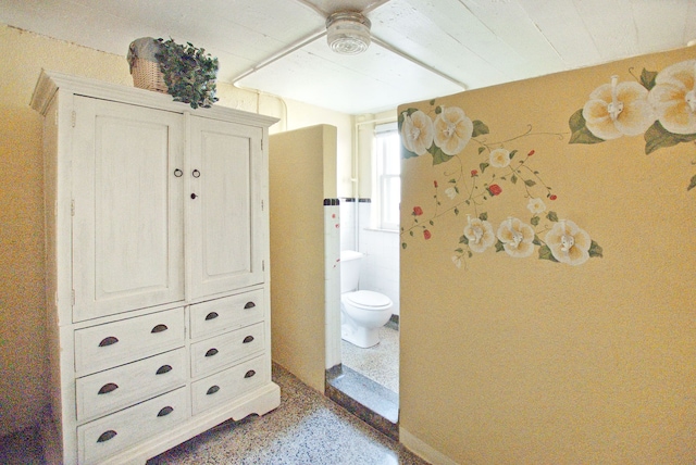 bathroom featuring ceiling fan and toilet