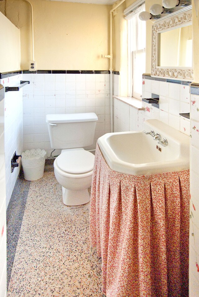 260 Oak Island Dr, Wolverine Lake, MI 48390 - bathroom featuring tile walls, toilet, a wainscoted wall, and vanity