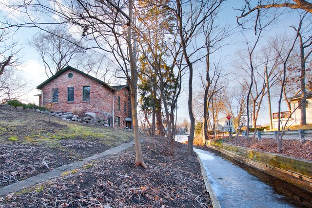 260 Oak Island Dr, Wolverine Lake, MI 48390 - view of side of home featuring brick siding