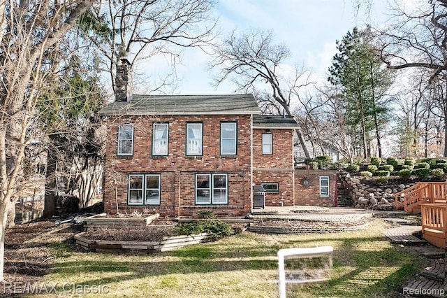 rear view of house with a lawn