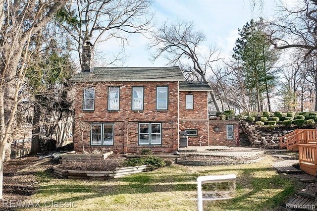 260 Oak Island Dr, Wolverine Lake, MI 48390 - rear view of property featuring a lawn, brick siding, and a chimney