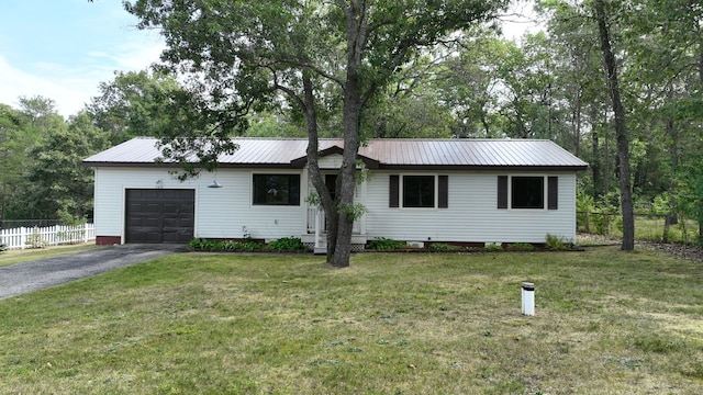 ranch-style home with a garage and a front lawn