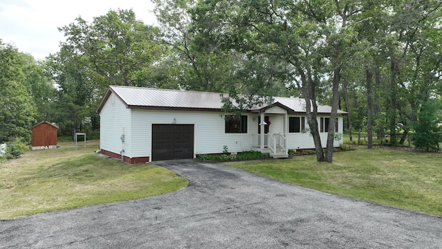 single story home featuring a garage and a front lawn