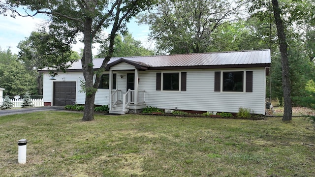 ranch-style house featuring a garage and a front yard