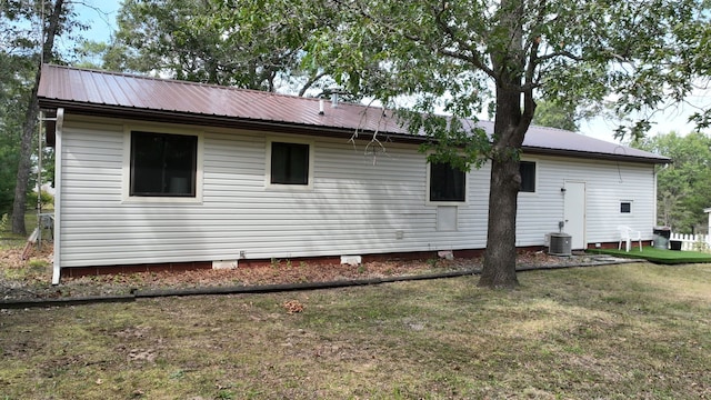 back of property featuring a yard and cooling unit