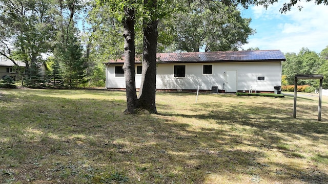 exterior space featuring central AC unit and a yard