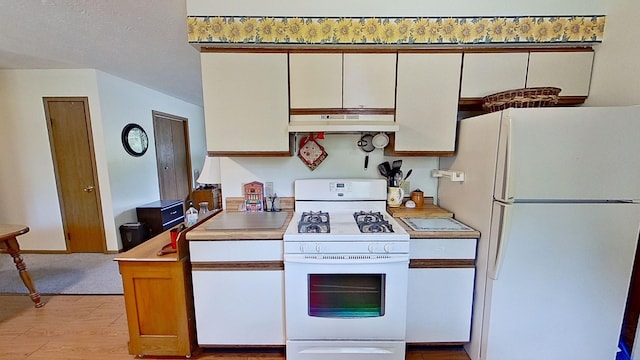 kitchen featuring light hardwood / wood-style flooring, white cabinets, and white appliances