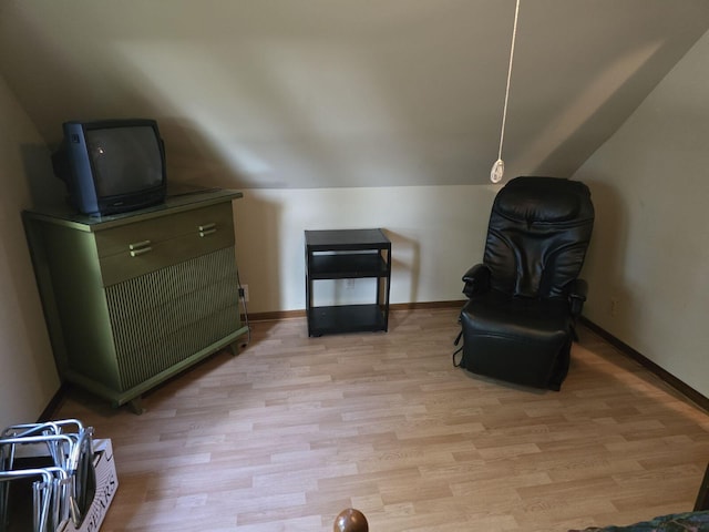 sitting room featuring light hardwood / wood-style floors and lofted ceiling