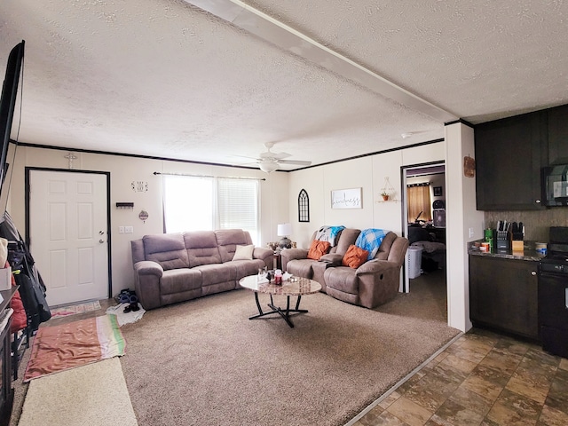 carpeted living room with ceiling fan and a textured ceiling