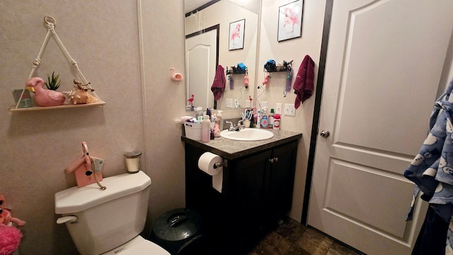 bathroom featuring vanity and toilet