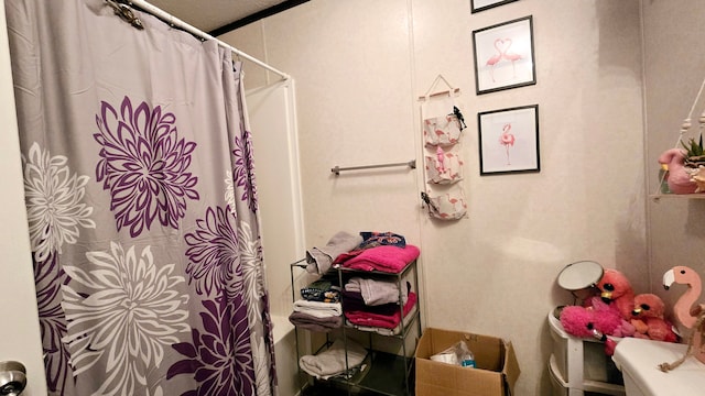 bathroom with toilet and curtained shower