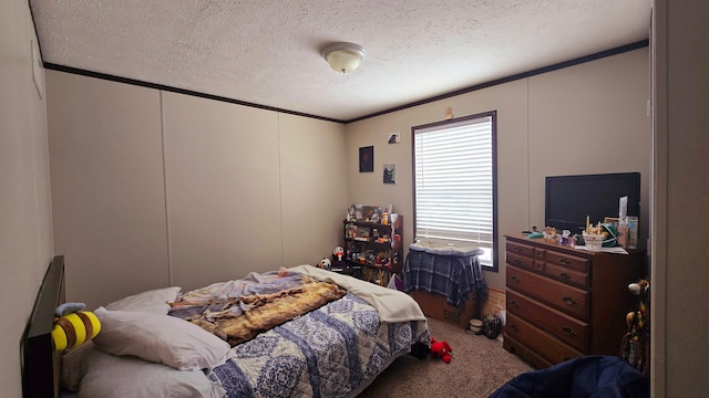 carpeted bedroom with ornamental molding and a textured ceiling