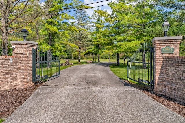 view of gate with a yard