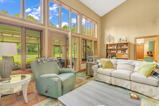 living room featuring a wealth of natural light and high vaulted ceiling