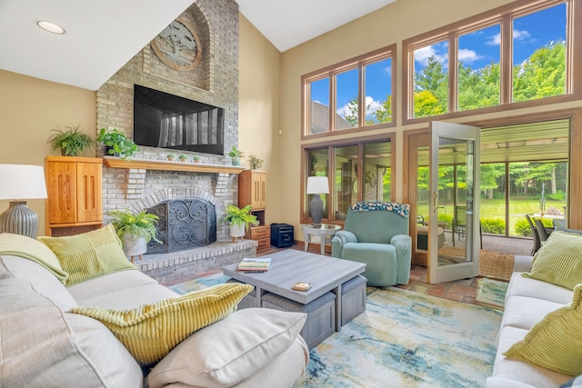 living room with a fireplace and high vaulted ceiling