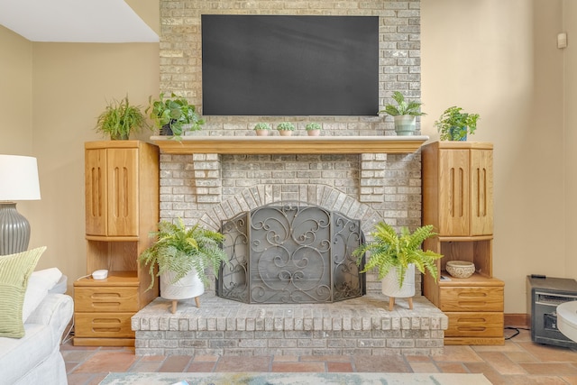 interior details featuring a brick fireplace