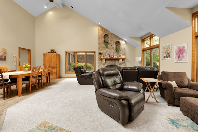 living room with a fireplace, high vaulted ceiling, ceiling fan, and beamed ceiling